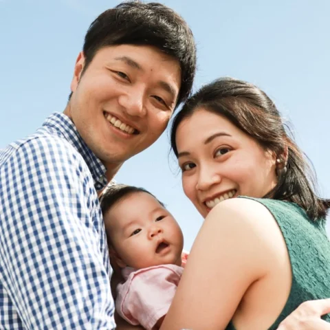 Asian couple holding a baby