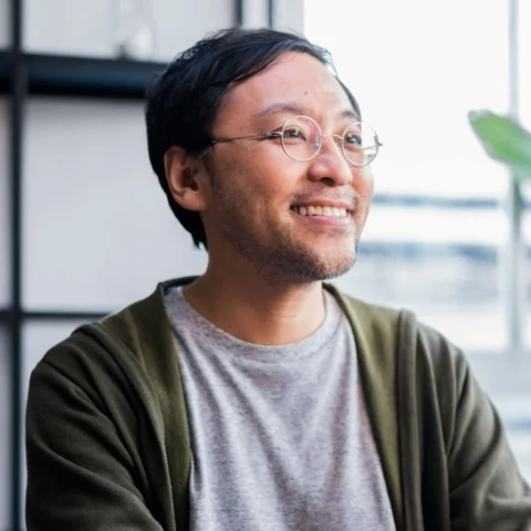 Man with glasses looking at the computer