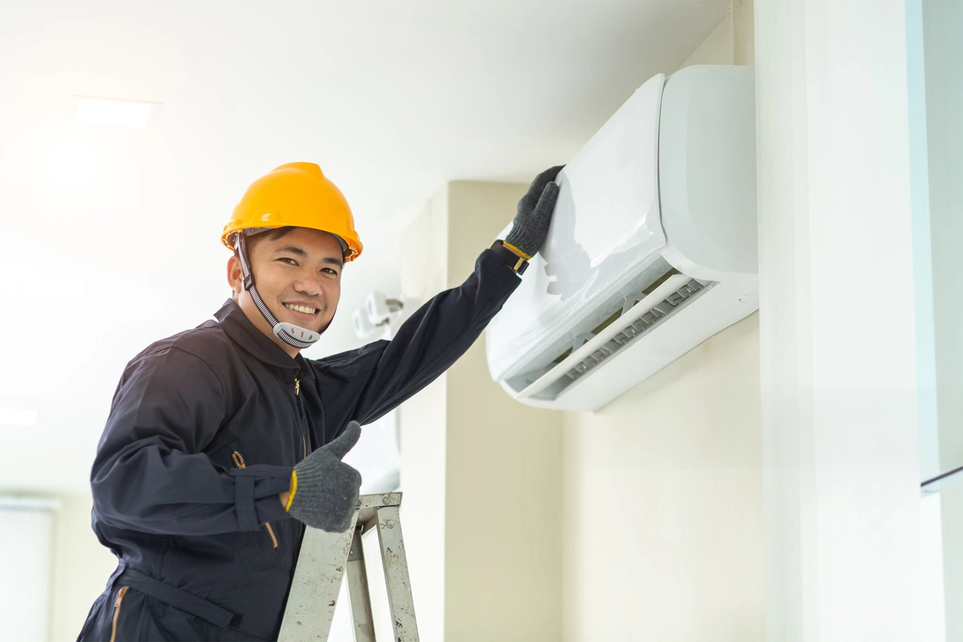 Portrait of technician repairing air conditioner