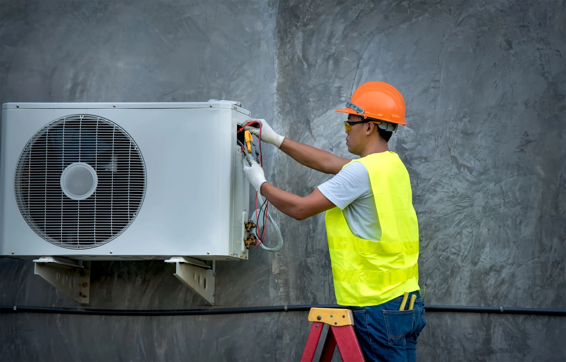 Worker repairing air conditioner